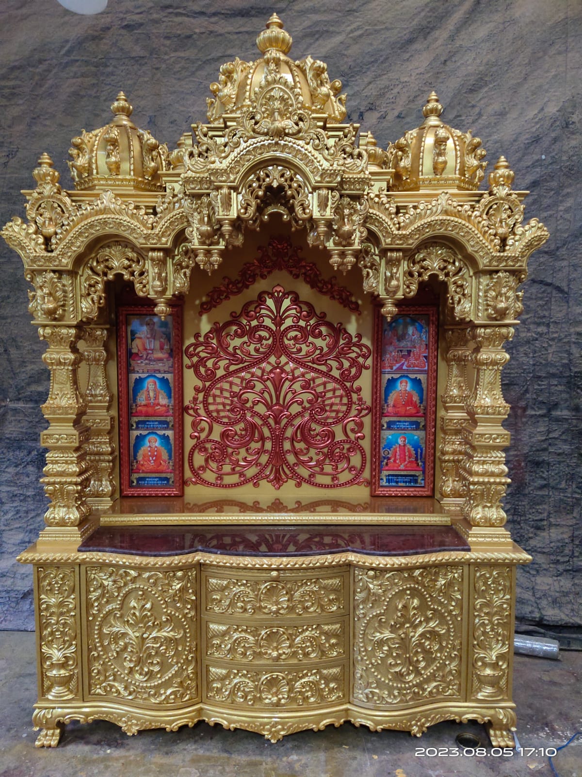 Gold-lacquered altar with hand-painted guardian panels.