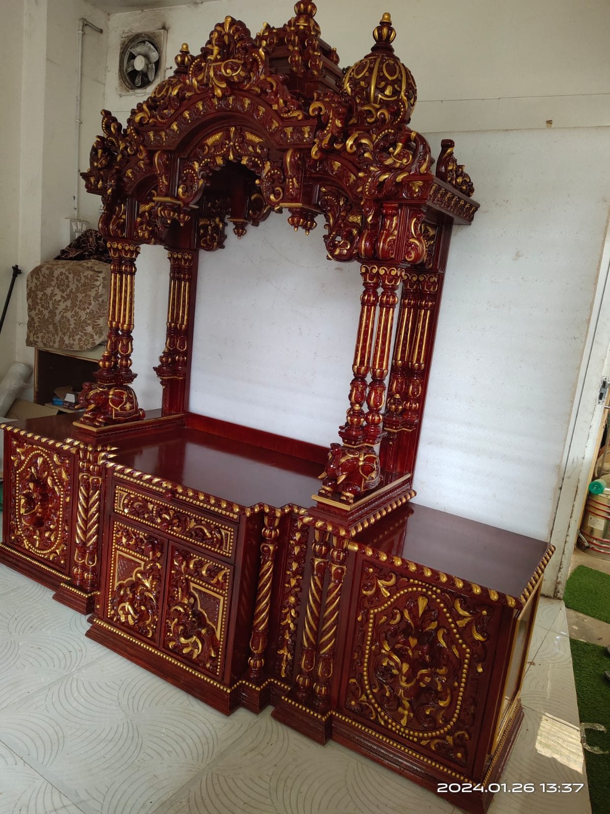 Hand-carved elephant motifs on a royal mandap canopy.
