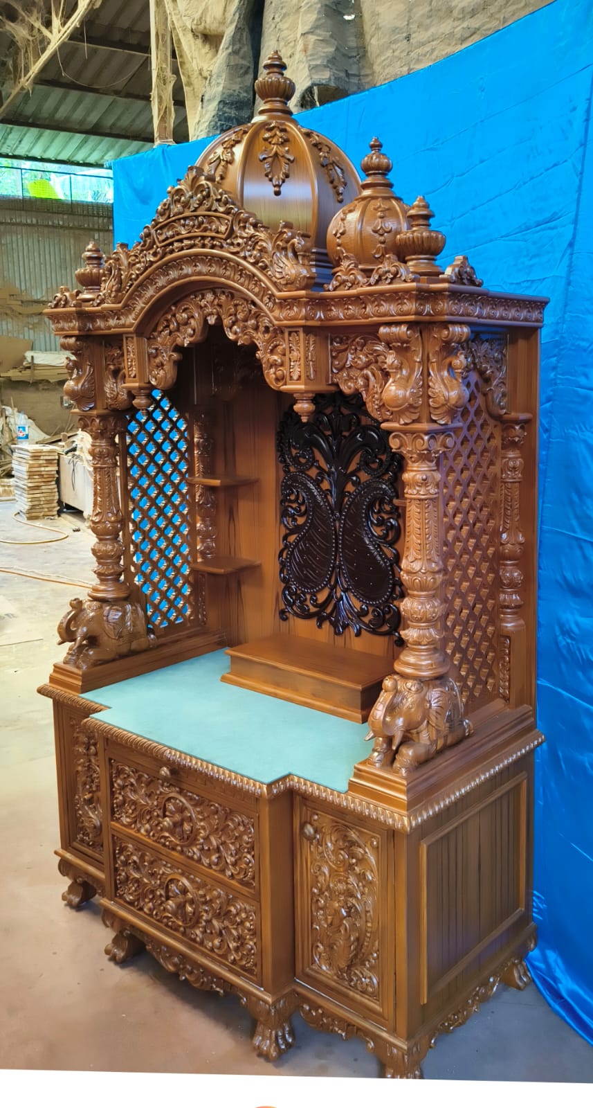 Wrought-iron carved back panel on a hand-carved home temple.